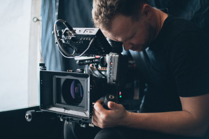 Director of photography with a camera in his hands on the set.