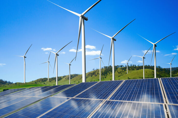 Solar energy panel photovoltaic cell and wind turbine farm power generator in nature landscape for production of renewable green energy is friendly industry. Clean sustainable development concept.