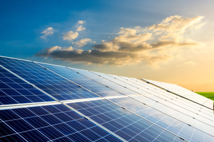 Solar power panels and beautiful natural landscape at sunset in summer in China