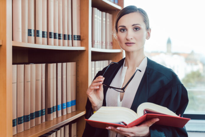 Lawyer working on a difficult case reading in the library