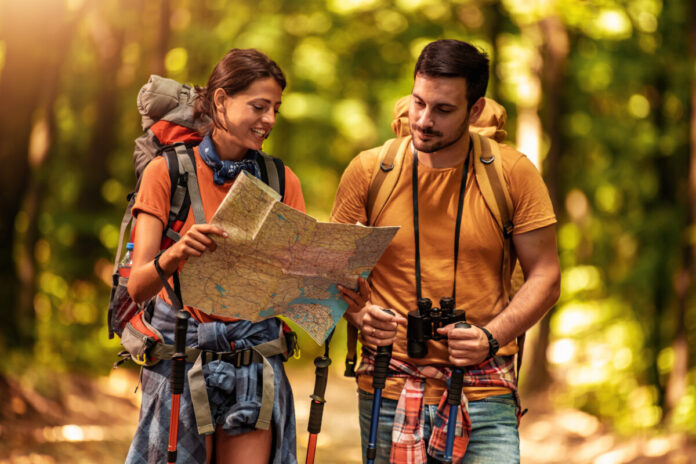 Cheerful couple hiking together in forest