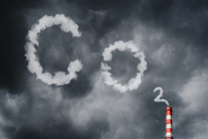 Air pollution by smoke coming out of factory chimney. Ecological problems. CO2 and greenhouse gas emissions