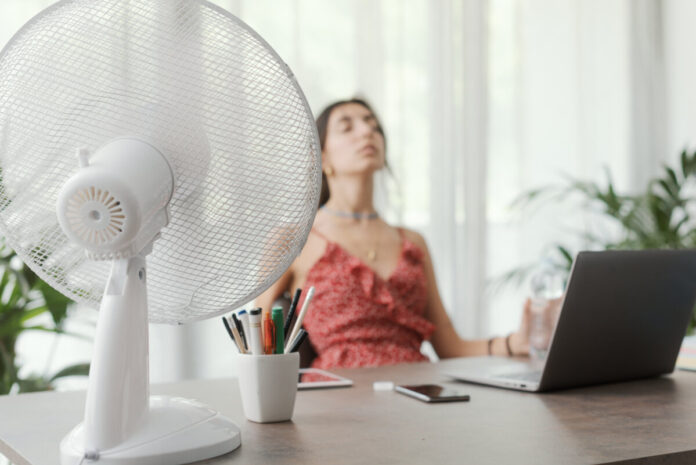 Woman cooling herself at home