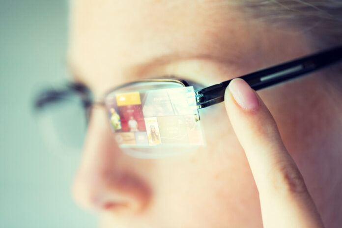 close up of woman in glasses with virtual screen